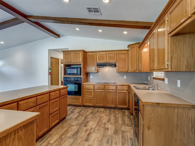 kitchen with black appliances, lofted ceiling with beams, sink, a textured ceiling, and light hardwood / wood-style floors