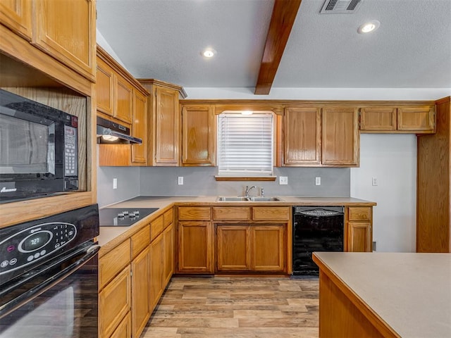 kitchen with beamed ceiling, sink, light hardwood / wood-style flooring, and black appliances