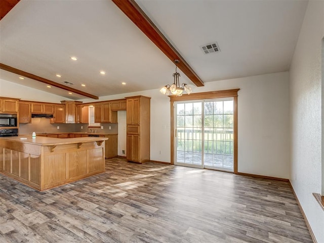 kitchen featuring lofted ceiling with beams, sink, decorative light fixtures, light hardwood / wood-style flooring, and a notable chandelier