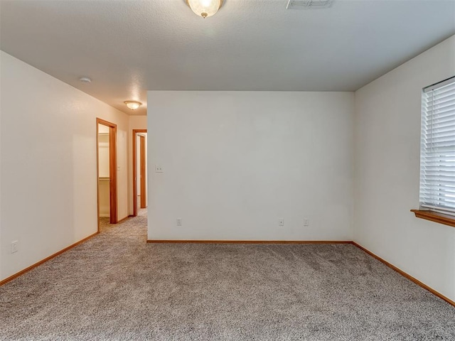 unfurnished room featuring light colored carpet