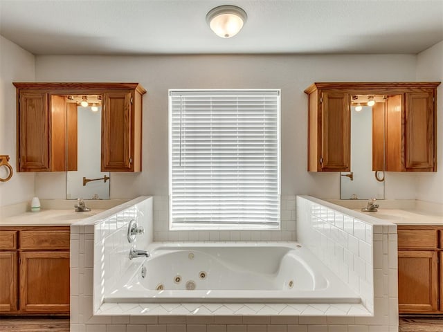 bathroom with vanity, a relaxing tiled tub, and hardwood / wood-style flooring