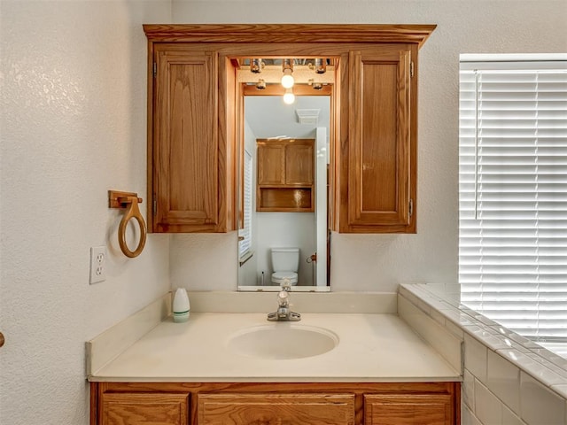 bathroom featuring vanity and toilet