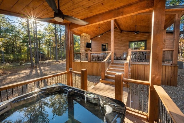 deck featuring a hot tub and ceiling fan