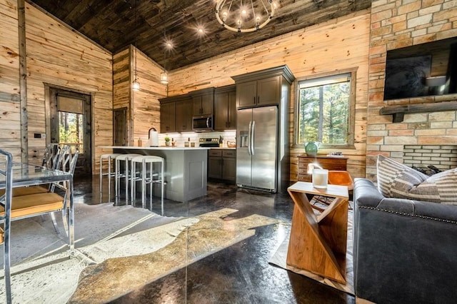 kitchen featuring high vaulted ceiling, dark brown cabinets, a healthy amount of sunlight, and appliances with stainless steel finishes