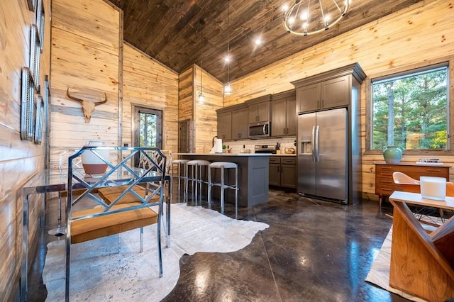 kitchen featuring high vaulted ceiling, a wealth of natural light, a center island, and appliances with stainless steel finishes