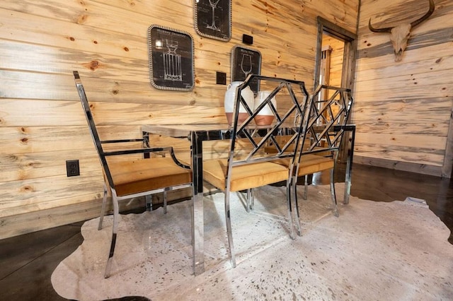 dining room with wooden walls