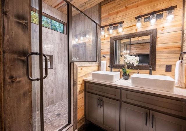 bathroom with vanity, an enclosed shower, and wooden walls