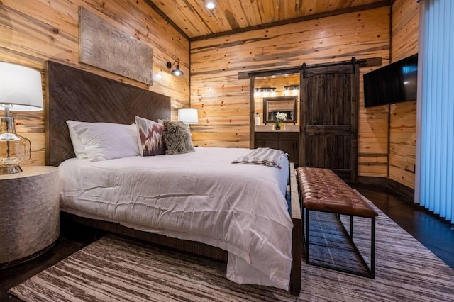 bedroom featuring a barn door, wood walls, dark hardwood / wood-style flooring, and wooden ceiling