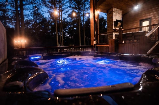 view of pool with a hot tub