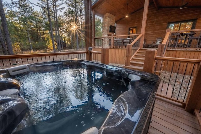 view of swimming pool featuring a wooden deck and ceiling fan