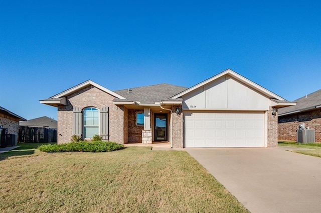 ranch-style home featuring a garage, brick siding, driveway, and a front lawn