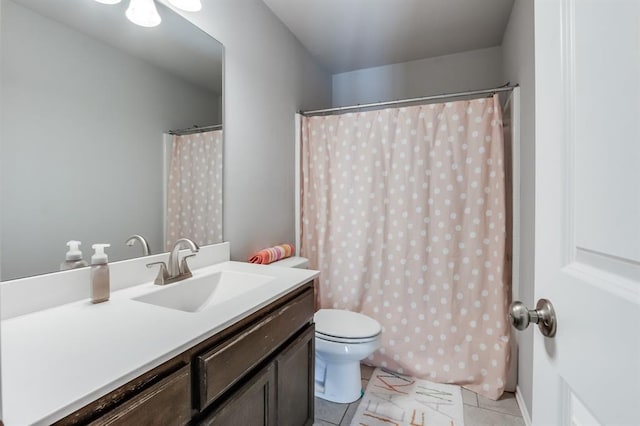 bathroom with toilet, tile patterned floors, and vanity