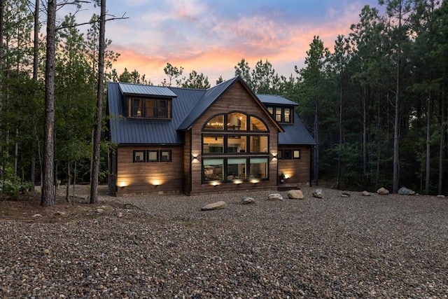 view of back house at dusk