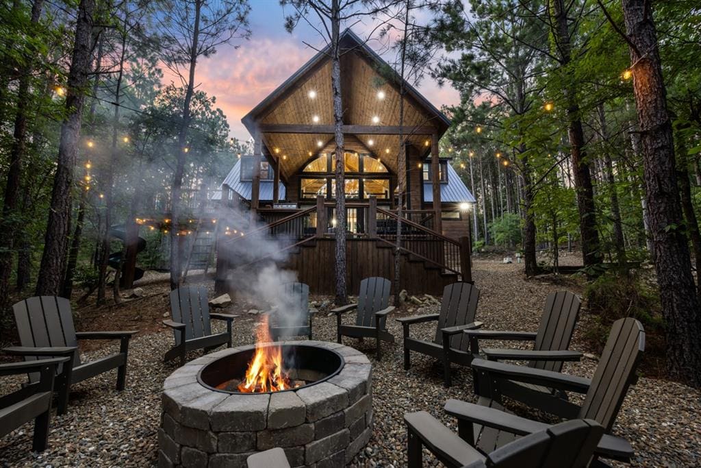 back house at dusk with an outdoor fire pit