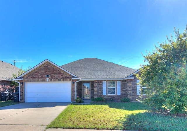 view of front of house featuring a garage and a front lawn