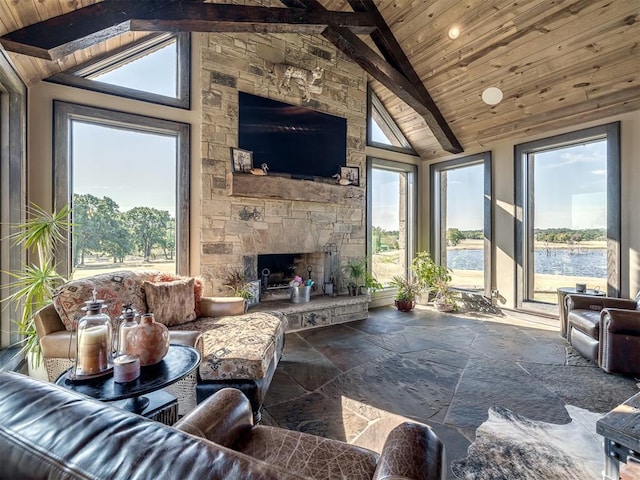 living room with beam ceiling, wood ceiling, a fireplace, and high vaulted ceiling