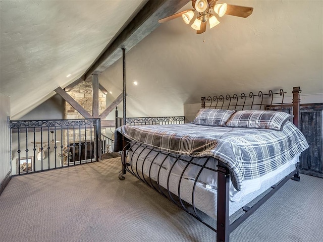 carpeted bedroom with vaulted ceiling with beams and ceiling fan