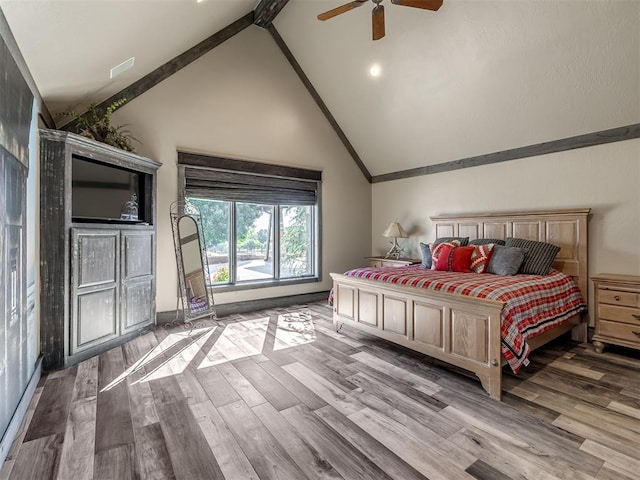 bedroom featuring beamed ceiling, wood-type flooring, high vaulted ceiling, and ceiling fan