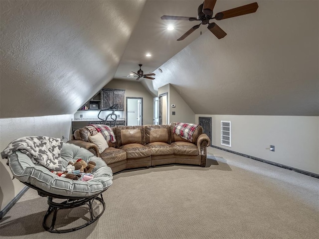 carpeted living room featuring ceiling fan and lofted ceiling