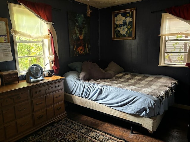 bedroom with dark wood-type flooring