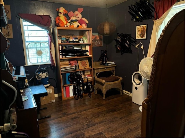 interior space with a textured ceiling and dark hardwood / wood-style flooring