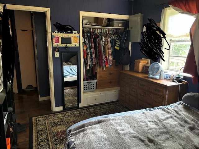 bedroom with dark wood-type flooring and a closet