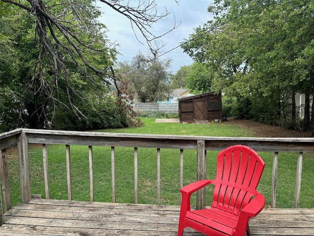 wooden deck with a storage shed and a lawn