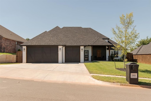 view of front facade featuring a garage and a front yard