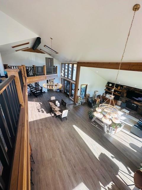 interior space with hardwood / wood-style flooring and vaulted ceiling