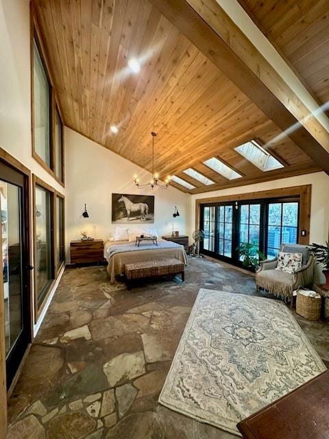 bedroom with vaulted ceiling with skylight, a chandelier, and french doors