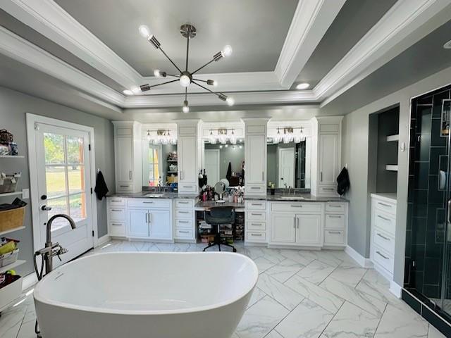 bathroom with vanity, separate shower and tub, crown molding, and a tray ceiling