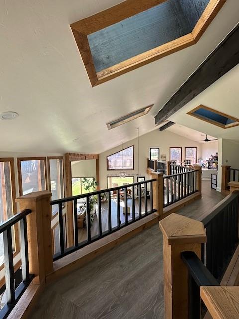 hallway with vaulted ceiling with beams and dark hardwood / wood-style floors