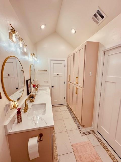 bathroom featuring vanity and vaulted ceiling