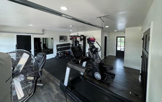 exercise room featuring dark wood-type flooring