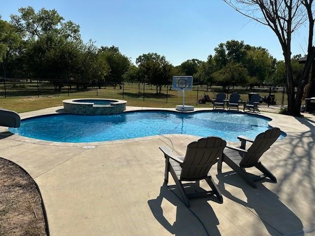 view of pool featuring an in ground hot tub and a patio