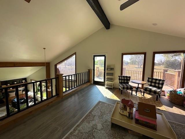 living room with vaulted ceiling with beams and dark wood-type flooring