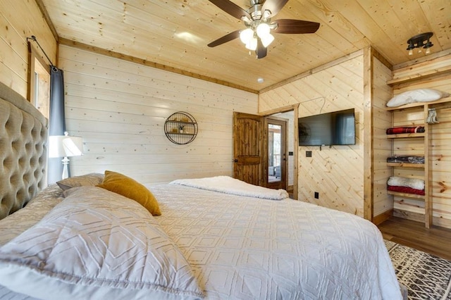 bedroom with hardwood / wood-style flooring, ceiling fan, wooden walls, and wood ceiling