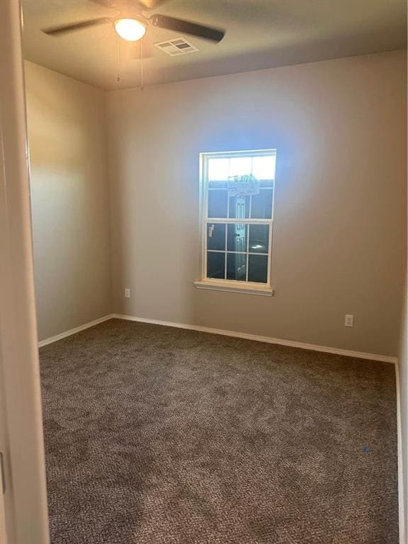 spare room featuring carpet flooring and ceiling fan