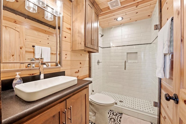 full bath featuring visible vents, toilet, a stall shower, wooden walls, and vanity