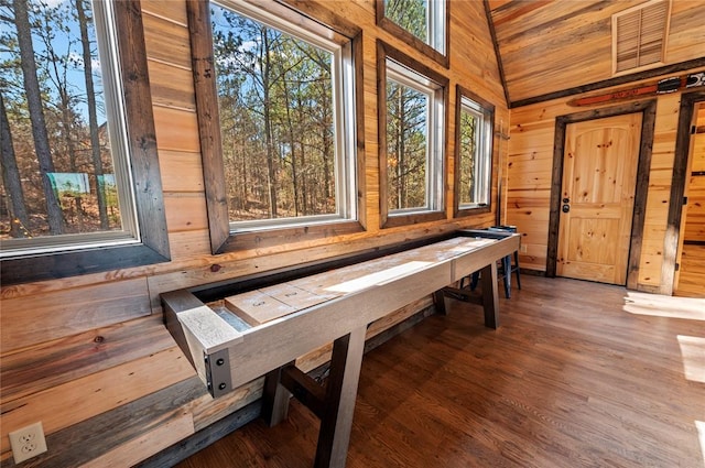 recreation room featuring wooden walls, visible vents, and wood finished floors