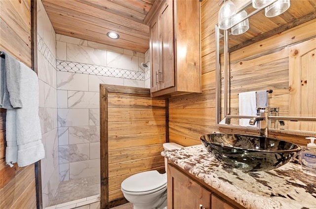 bathroom featuring toilet, wooden ceiling, a walk in shower, and vanity