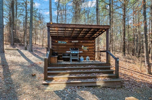 deck featuring grilling area and an outbuilding