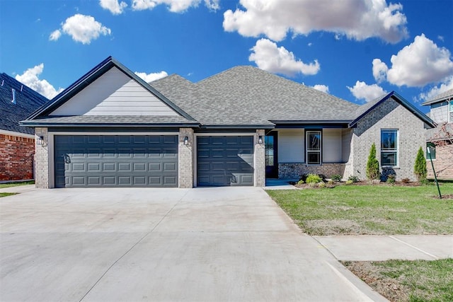 view of front of property with a garage and a front yard