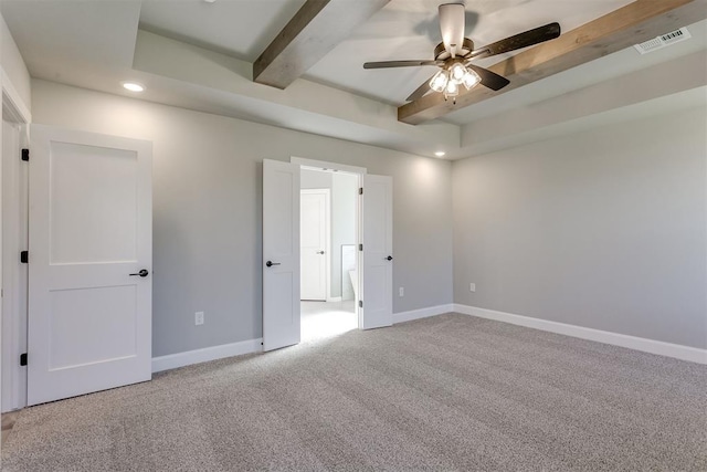 carpeted spare room featuring beamed ceiling and ceiling fan