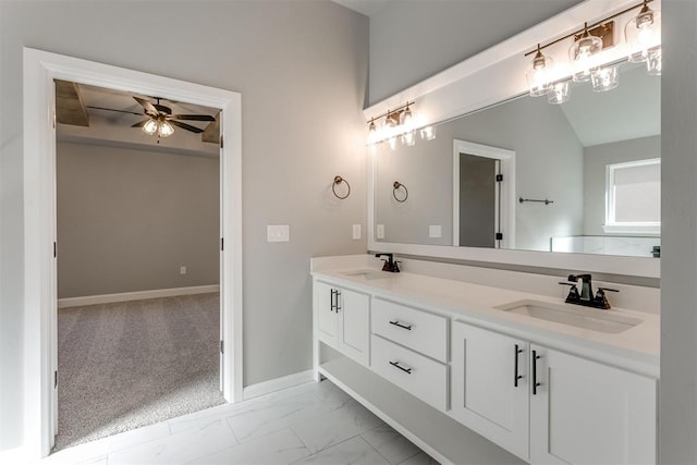 bathroom with ceiling fan, vanity, and lofted ceiling