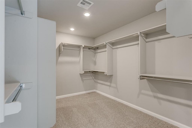 walk in closet with carpet