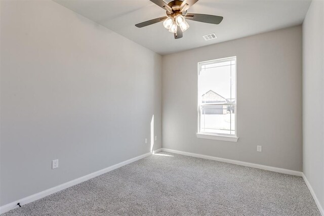 spare room featuring ceiling fan and carpet