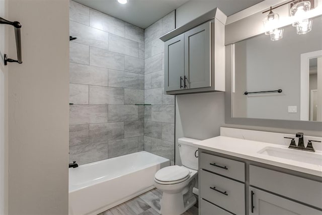 full bathroom featuring vanity, toilet, and tiled shower / bath