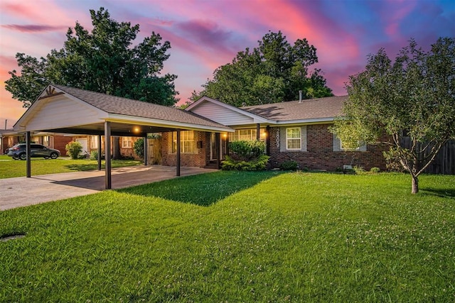 single story home featuring a yard and a carport