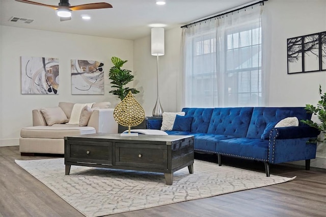 living room with hardwood / wood-style flooring and ceiling fan